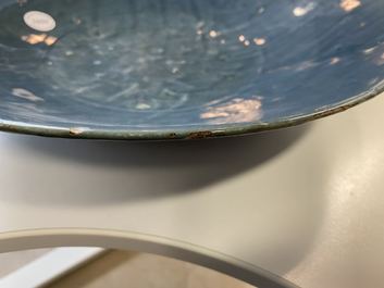 A Chinese monochrome blue Swatow dish with incised carp design, Ming